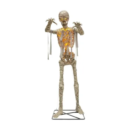An eleven foot LED mummy standing on a lawn at night